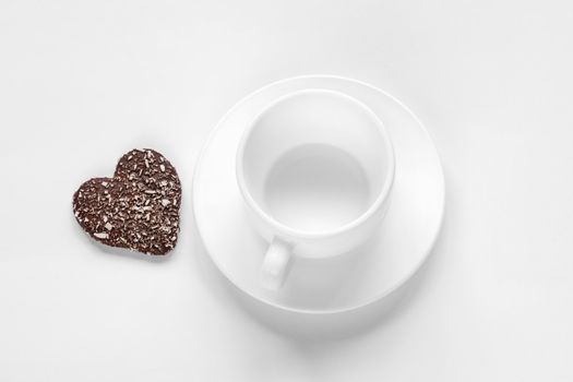 cup and saucer and a chocolate coconut cookies