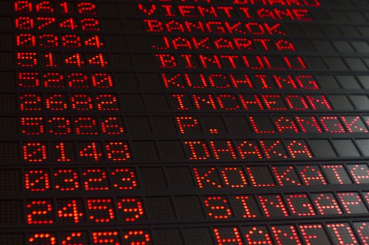 airport departures board that shows asian destinations.