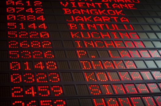 airport departures board that shows asian destinations.