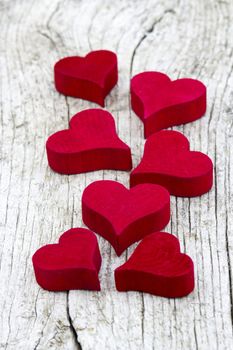 red hearts on old wooden background