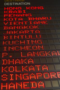 airport departures board that shows asian destinations.