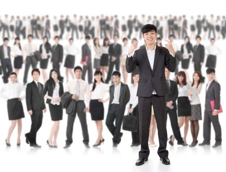 Young cheerful businessman of Asian point at himself and stand in front of huge group business people on white background. Concept of cheerful, confident, successful and volunteer idea.
