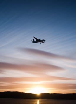 Airplane in blue sky during sunset
