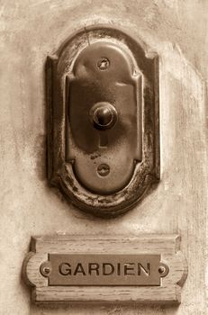 Old French doorbell sepia toned with concierge label