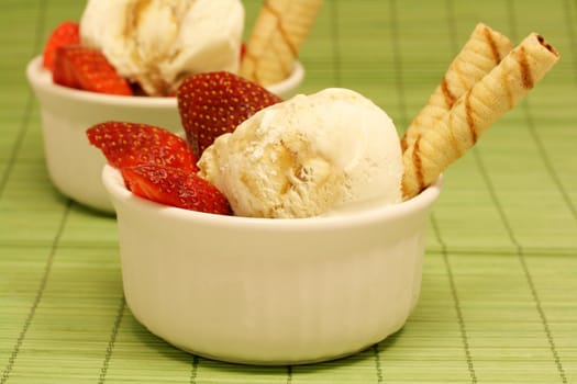 Vanilla ice cream scoops with strawberries