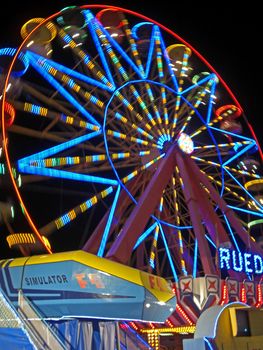 Moving fairground wheel ful of colerfull lights