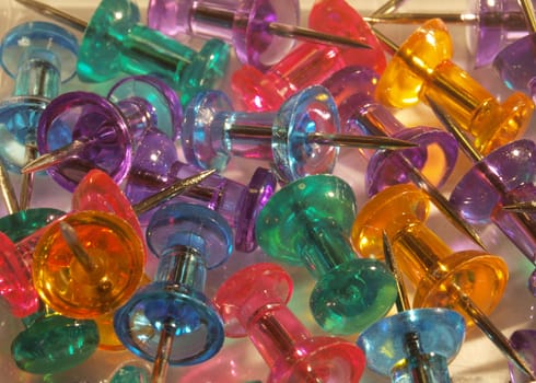 Close up of multicoloured thumbtacks. 