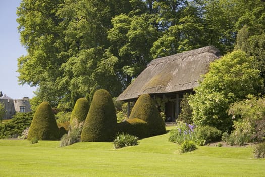 A thatched summerhouse in a baeutiful garden