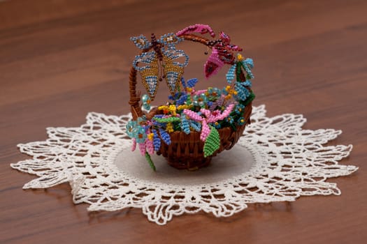 little crib with handmade flowers on brown table
