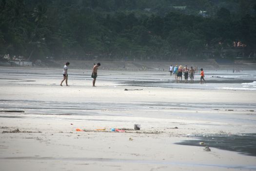 tourists walking on the beach on white sand beach koh chang island thailand