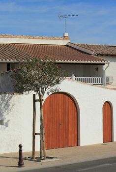 White house at Saintes-Maries-de-la-mer, Camargue, France, by beautiful summer day