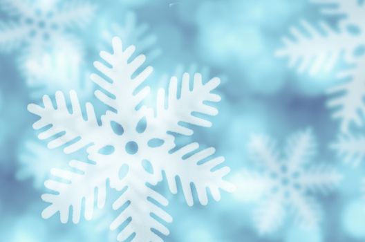 Winter blue background with snowflakes falling.