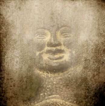 background smiling Buddha carved into a stone wall