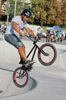 GENEVA, SWITZERLAND - SEPTEMBER 2 : Teenager biker jumping on the brand new skate park on September 2, 2012, in Geneva, Switzerland.