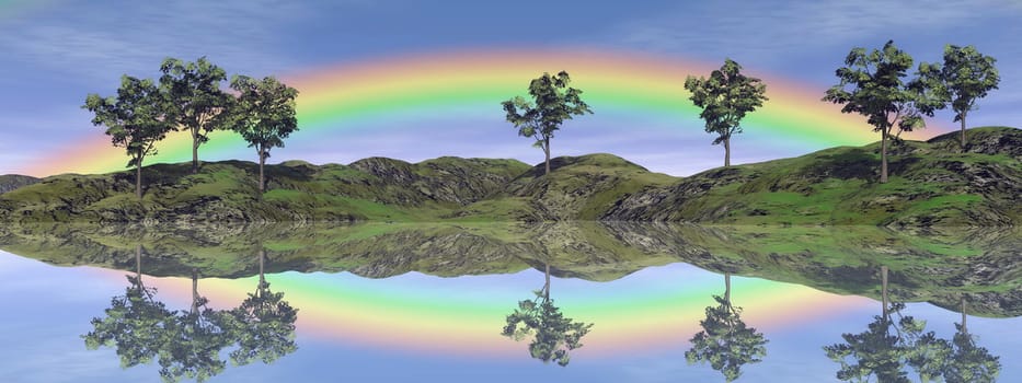 Beautiful rainbow upon trees and grassland with its reflection in the water