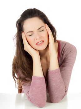 Beautiful young woman with a  bad headache touching her head. Isolated on white.