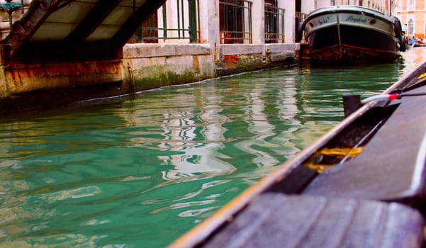 Canal of Venice with  bouts. blue water.