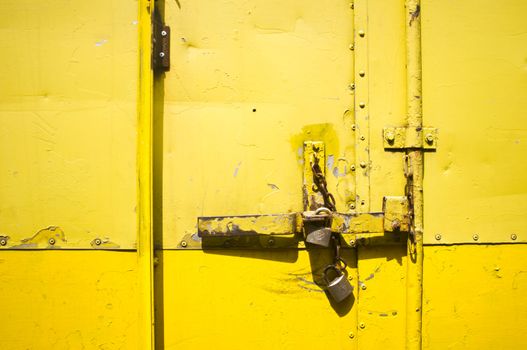 yellow metal door latch and lock, for conceptual background.
