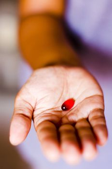 a red tablet is handed out by a woman.