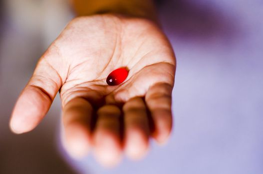 a red tablet is handed out by a woman.