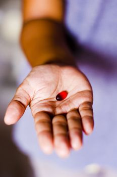 a red tablet is handed out by a woman.
