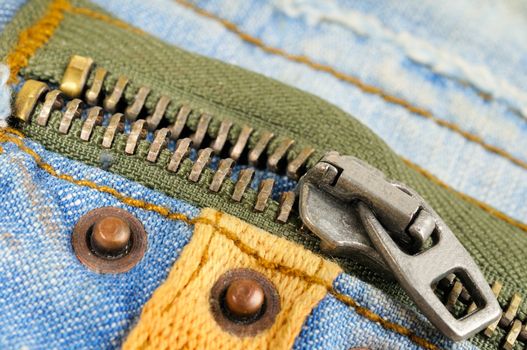 Zipper on the pocket of jeans. Macro photo.