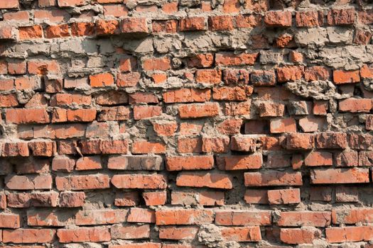 Old dilapidated brick wall of red brick