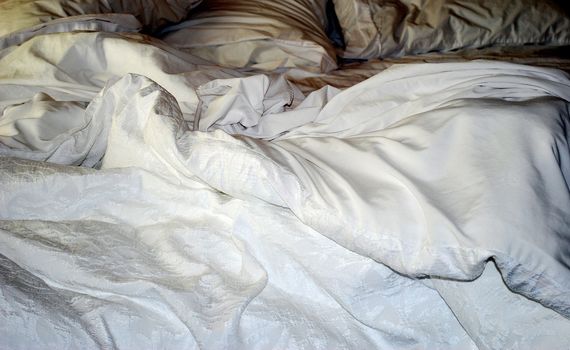 Silk bedding on a luxury, bed.