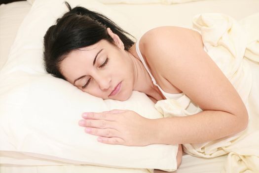 Portrait of beautiful young woman sleeping on the bed.