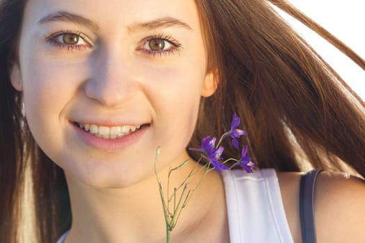 portrait of a beautiful young woman with flower  outdoor