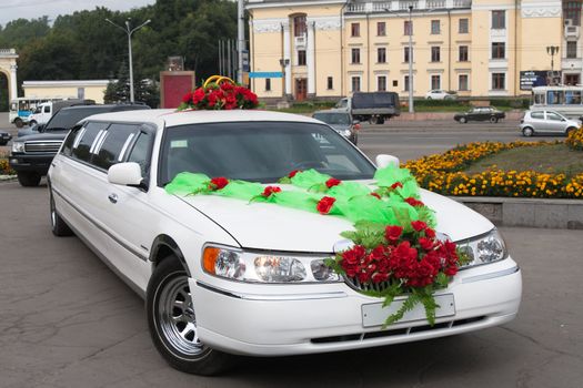  White wedding limousine decorated with flowers 