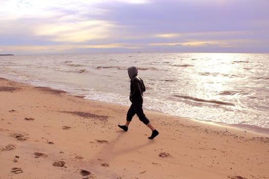 A man going along a coast of gulf of Finland
