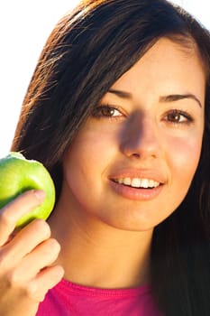 portrait of a beautiful young woman with apple  outdoor