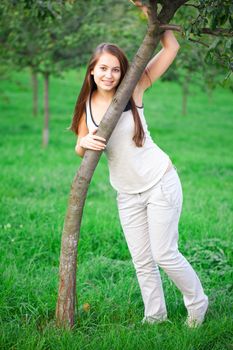 beautiful young woman standing on green grass