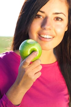 portrait of a beautiful young woman with apple  outdoor