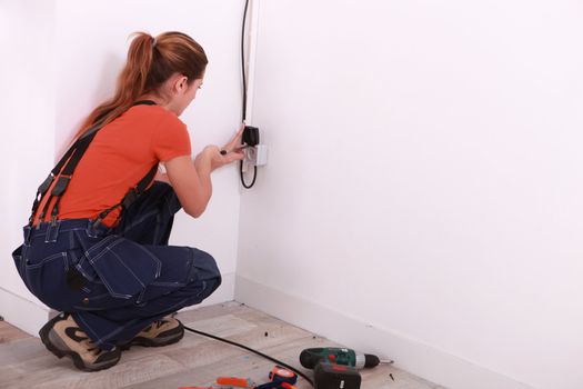 Young woman installing wiring