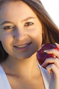 portrait of a beautiful young woman with apple  outdoor