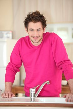 Man standing in front of his kitchen sink