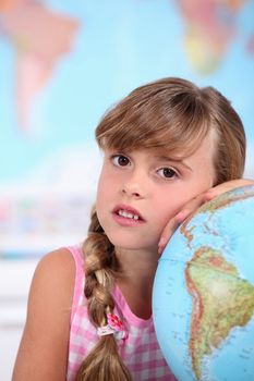 A little girl learning geography.