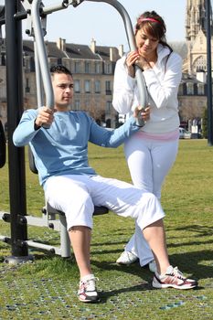 Couple doing gymnastics outdoors