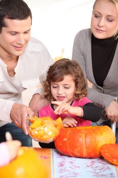 Family carving hallowe'en pumpkin