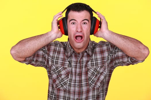 craftsman wearing headphones can't stand the noise