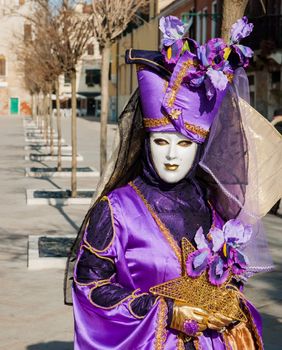 VENICE: An unidentified masked person in costume in St. Mark's Square during the Carnival of Venice, 2010.