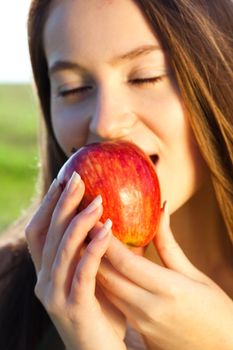 portrait of a beautiful young woman with apple  outdoor