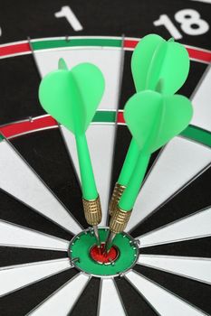 Dartboard bull�s eye. Three darts on center