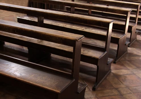 Worn Church pews in a basilica in Italy.
