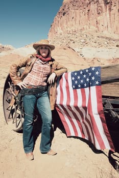 portrait of a young cowgirl with american flag