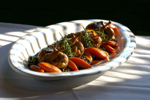 Image of baked quail over lentils with vegetables