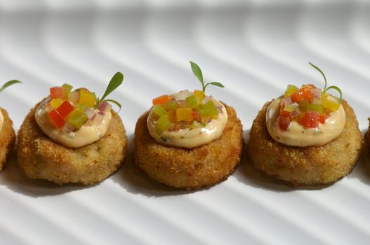 Image of miniture crab cakes with garnish