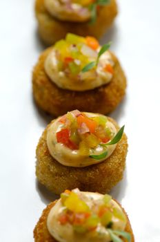 Image of miniture crab cakes with garnish